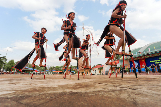 Stilt performers seen at a traditional festival.