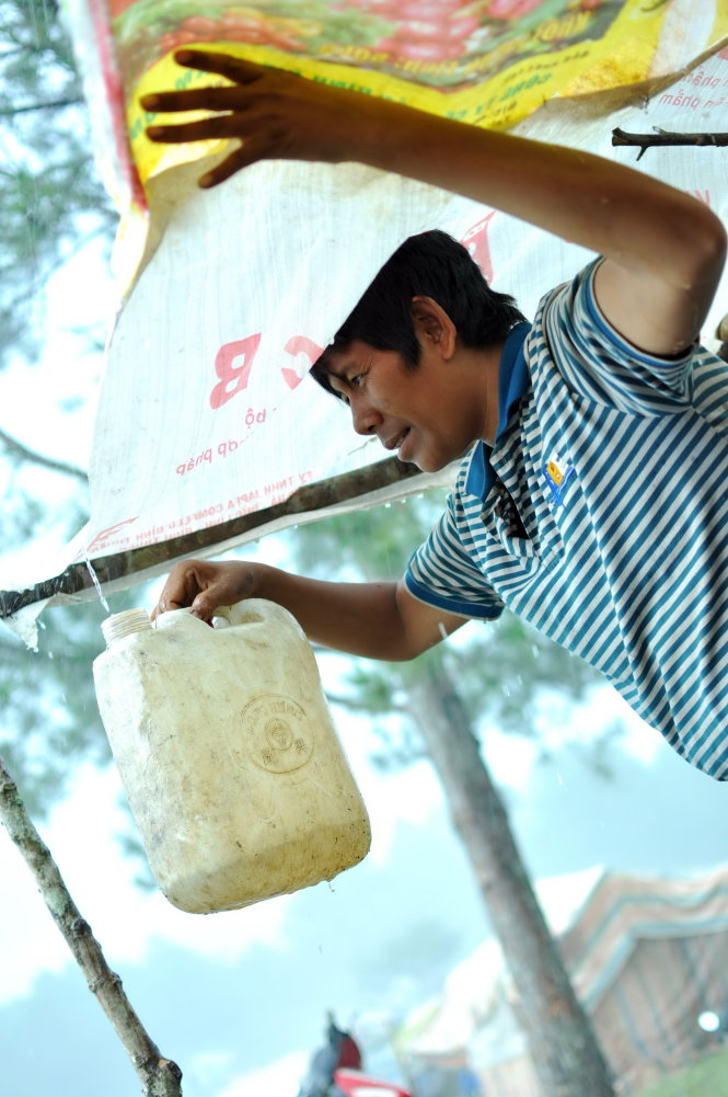 Residents mainly use rainwater and spring water as the two main sources of domestic water supply. In this photo, Loc, a resident, is seen collecting rainwater.