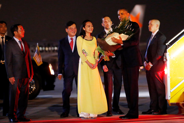 U.S. President Barack Obama receives flowers as he arrives at Noibai International Airport in Hanoi, Vietnam May 22, 2016.
