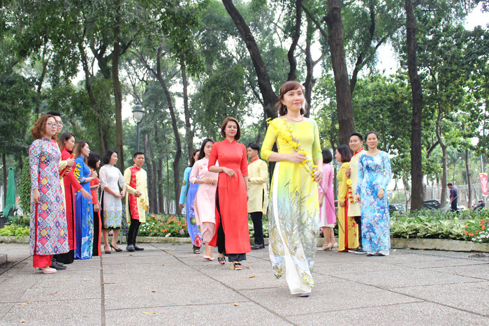 Women in the ao dai have an outdoor “catwalk show” at the park. Photo: Tuoi Tre