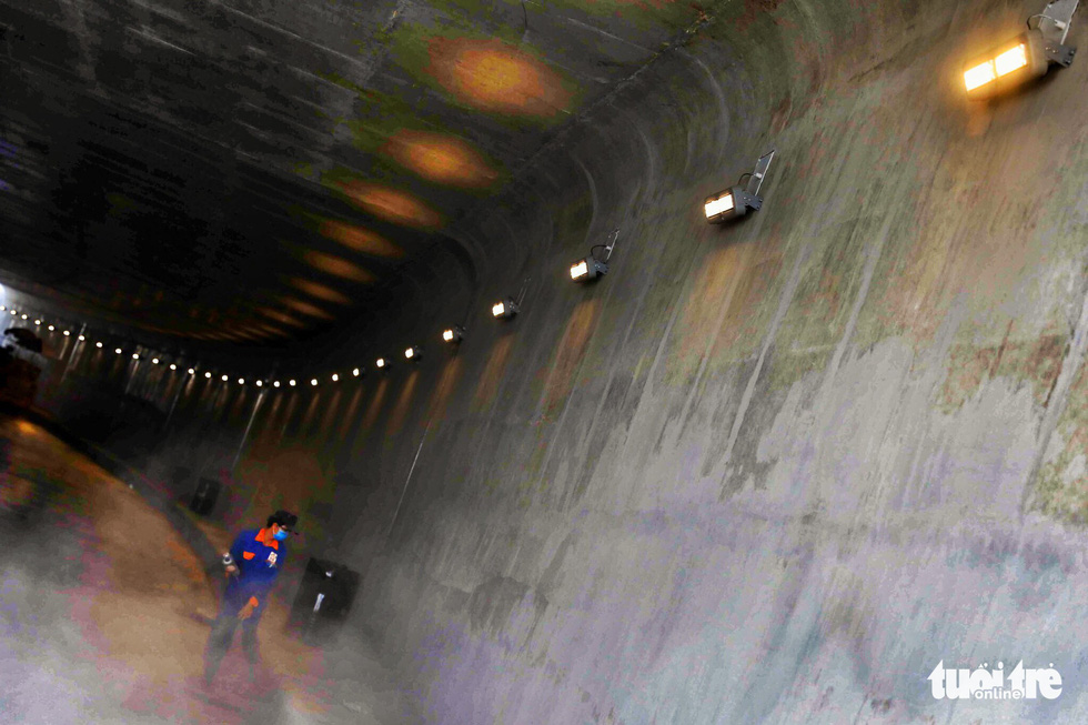 A worker cleans the inside of the first branch of the An Suong underpass in Ho Chi Minh City. Photo: Tuoi Tre