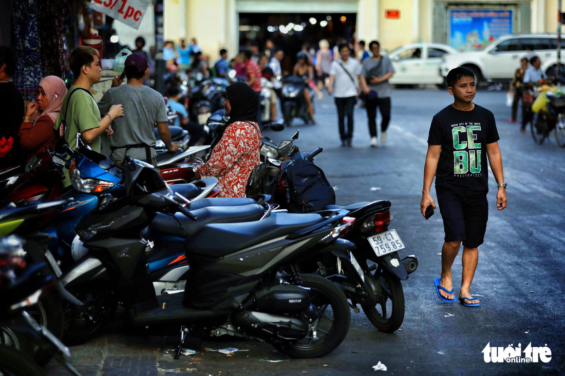 Motorcycles are parked on the pavement on Nguyen An Ninh Street in District 1, Ho Chi Minh City, Vietnam. Photo: Tuoi Tre