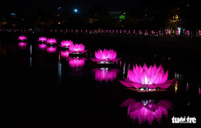 Seven large lotus-shaped lanterns by Quan Am Monastery are seen on Nhieu Loc – Thi Nghe Canal in Ho Chi Minh City. Photo: Tuoi Tre