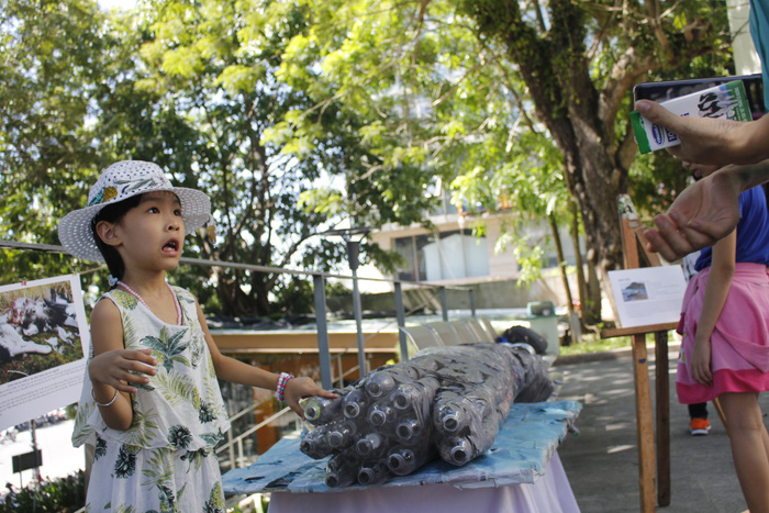 A girl expresses her surprise when her mother tells that a sperm whale found in Spain died from plastic, while standing by a displayed object at the ‘Plastic Monster’ exhibition in Da Nang, Vietnam, June 30 and July 1, 2018. Photo: Tuoi Tre