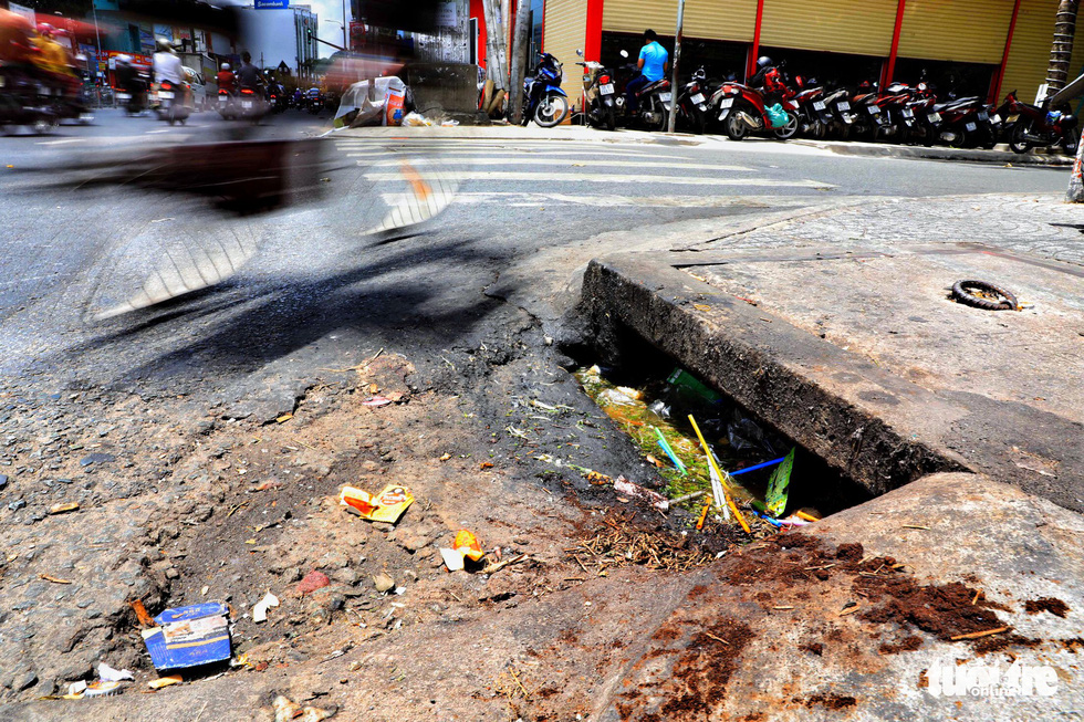 A sewer is polluted by food waste on Bach Dang Street in Binh Thanh District.