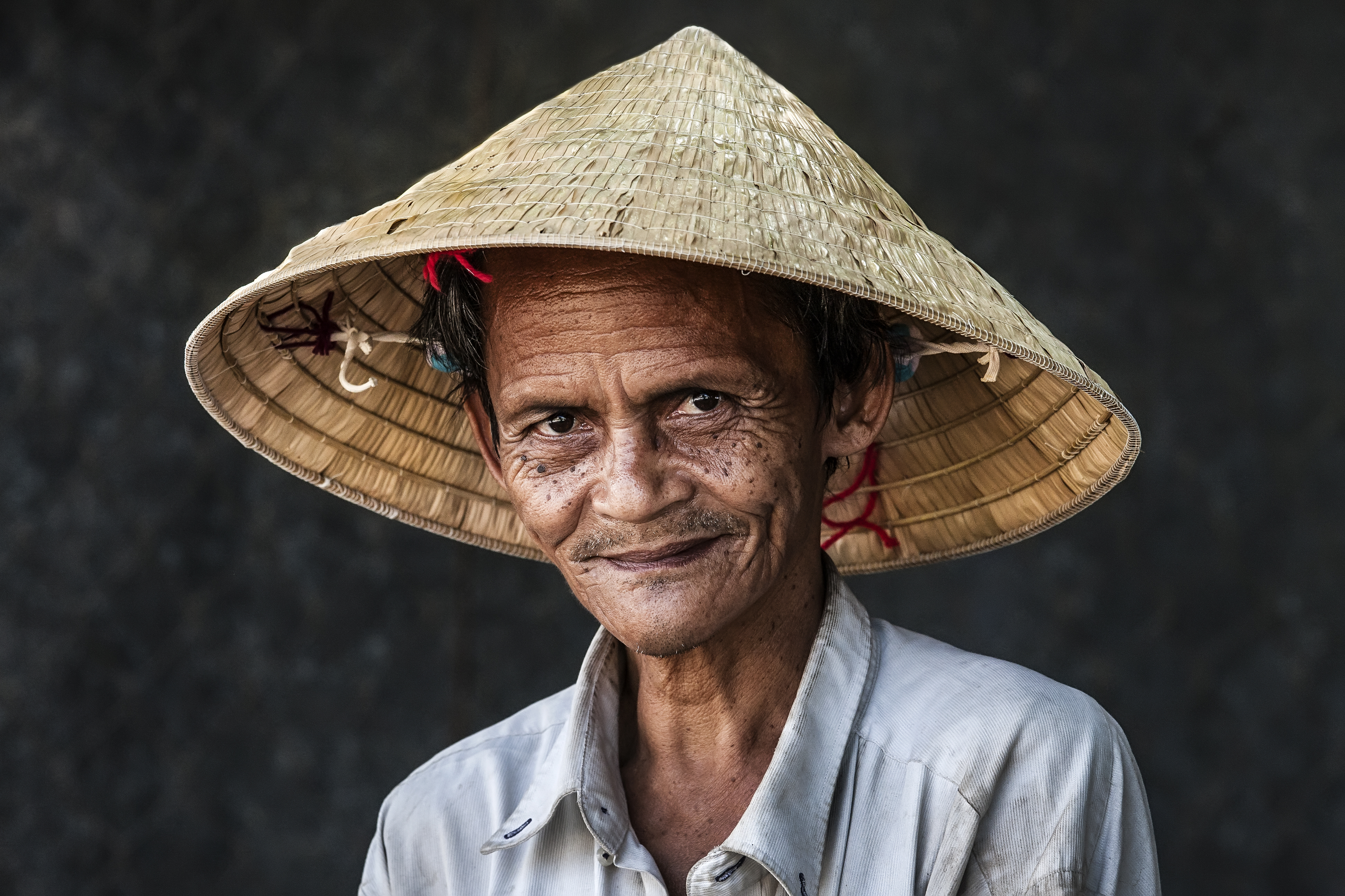 A farmer wears Vietnamese traditional conical hat