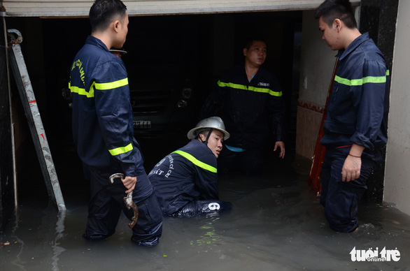 Firefighting officers work to ‘rescue’ a flooded parking basement. Photo: Tuoi Tre