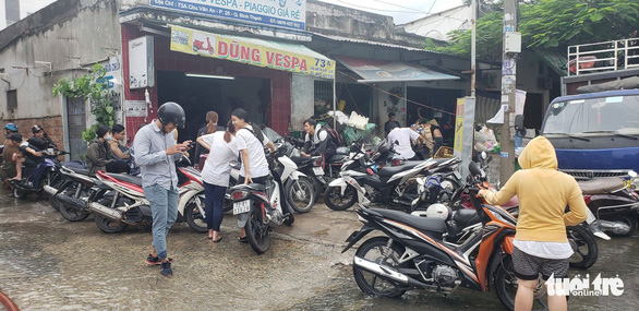 A motorbike repair store is filled with customers. Photo: Tuoi Tre
