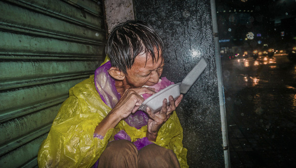 A man eats banh bao along a street in Ho Chi Minh City, Vietnam. Photo: Huynh Quang Huy