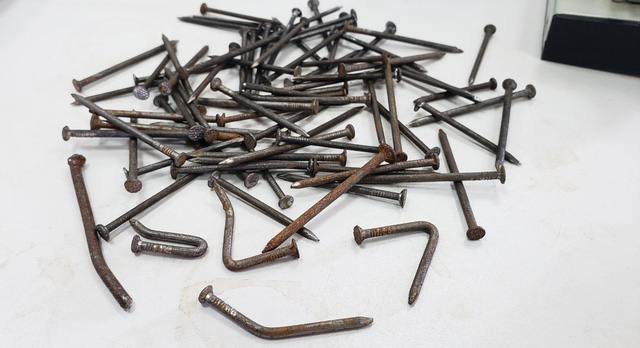 Some of the iron nails are bent into an L-shape to increase their chances of ripping into vehicles’ tires. Photo: Tuoi Tre