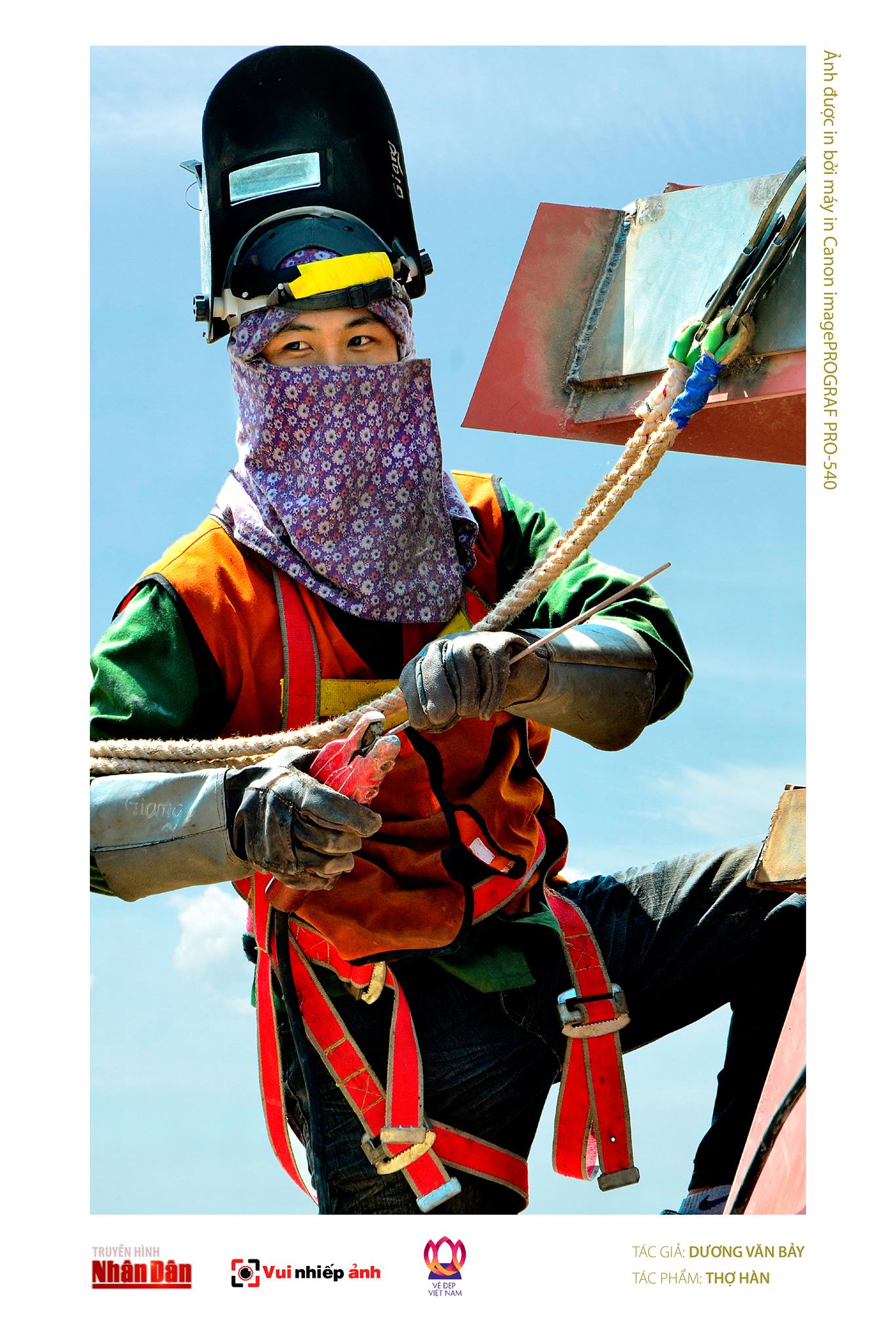 A photo captures a female welder working