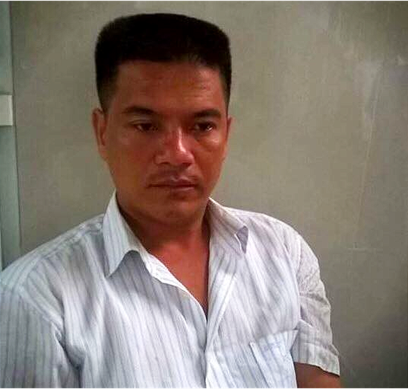 Pham Thanh Hieu, the truck driver, is held at the police station in this photo supplied by officer.  