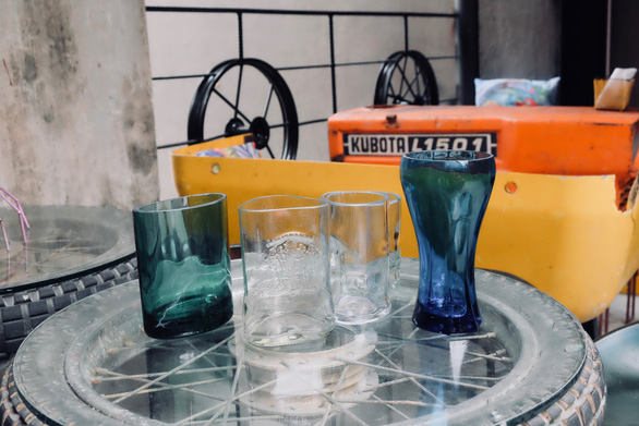 Cups from disposed of bottles are seen at Nguyen Van Tho’s coffee shop in Hanoi, Vietnam. Photo: Tuoi Tre