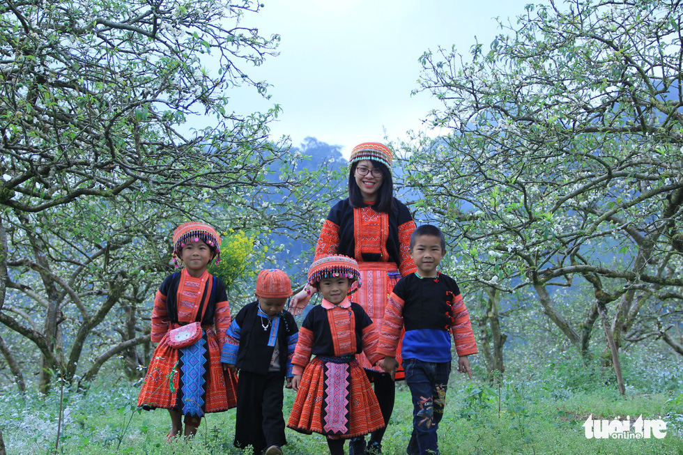 Residents of the local Mong ethnic minority visit a blossoming plum garden in Moc Chau. Photo: Tuoi Tre