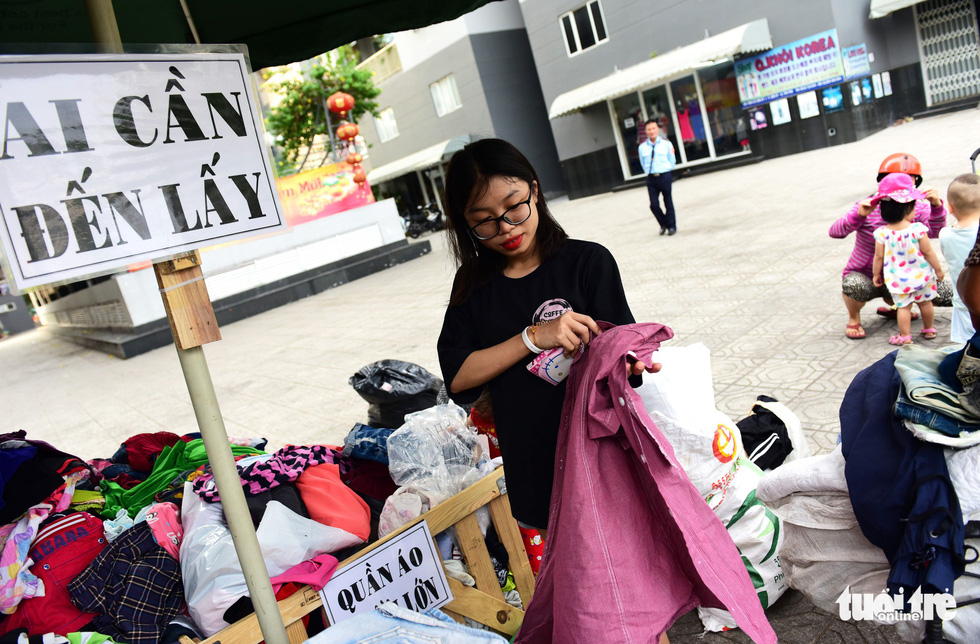 A woman rearranges clothes put in a box at the Son Ky 1 Apartment Building Complex in Ho Chi Minh City, Vietnam. Photo: Duyen Phan / Tuoi Tre
