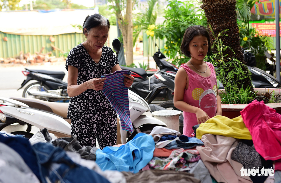 A woman chooses clothes at the Son Ky 1 Apartment Building Complex in Ho Chi Minh City, Vietnam. Photo: Duyen Phan / Tuoi Tre