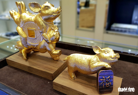 Gold plated pig statues like these may rake in millions of VND from wealthy customers during the Lunar New Year season. Photo: Ngoc Hien / Tuoi Tre