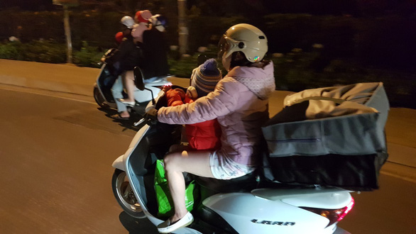A woman and her child look for a hotel room in Da Lat on the night of February 8, 2019. Photo: Khac Tuan / Tuoi Tre