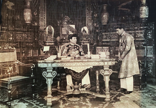 Emperor Khai Dinh (L) works at the Kien Trung Palace in the Forbidden City in Hue. Photo: Hue Monuments Conservation Center
