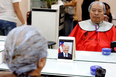 Le Phuc Hai, 66, dyes his hair to get a U.S. President Donald Trump style haircut in a salon in Hanoi, Vietnam February 19, 2019. Photo: Reuters