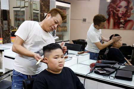 To Gia Huy, 9, has a haircut in a North Korean leader Kim Jong Un style in a haircut salon in Hanoi, Vietnam February 19, 2019. Photo: Reuters