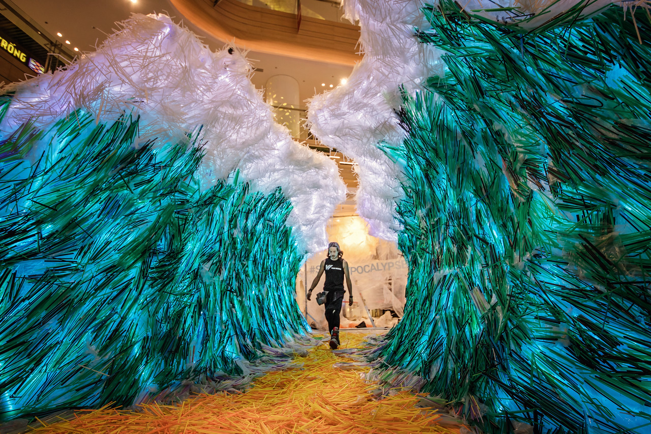 Benjamin Von Wong walks through his art installation titled The Parting of The Plastic Sea in Ho Chi Minh City. Photo: Anna Tenne/Supplied by Von Wong