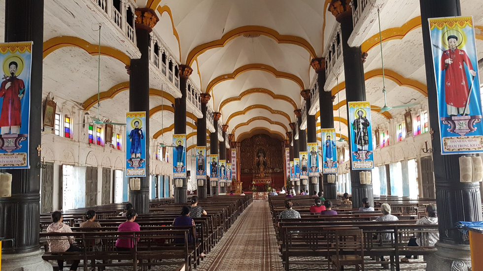 People sit inside the church at the Bui Chu Diocese in Nam Dinh Province, northern Vietnam. Photo: Thai Loc / Tuoi Tre