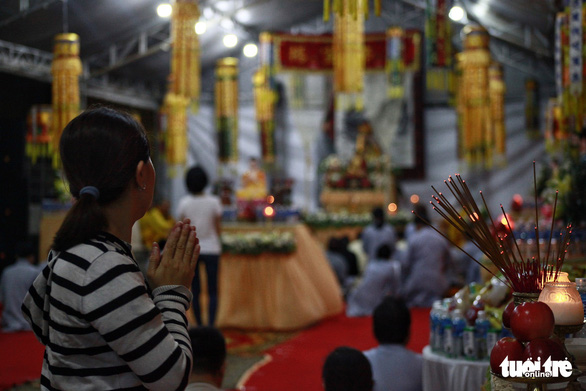 A resident participates in a prayer service at the Carina Plaza apartment complex in District 8, Ho Chi Minh City, March 11, 2019. Photo: Hoang Dong / Tuoi Tre