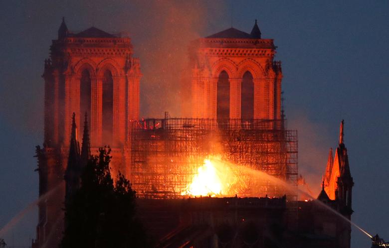 Smoke billows as fire engulfs the spire of Notre-Dame Cathedral in Paris, April 15. REUTERS/Benoit Tessier