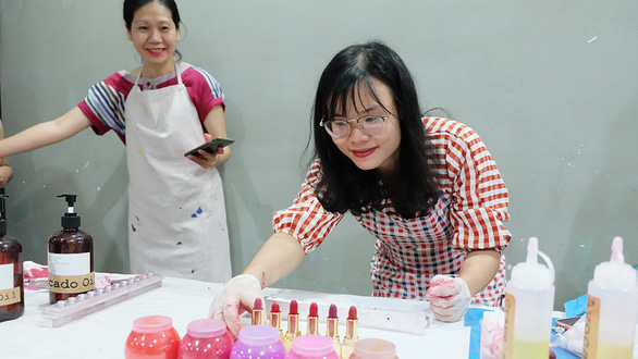 Tang Boi Quan at a workshop instructing others how to make handmade lipsticks safe for health. Photo: Tuoi Tre