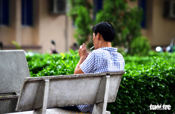 A man smokes on a bench at Children’s Hospital 2 in District 1, Ho Chi Minh City. Photo: Duyen Phan / Tuoi Tre