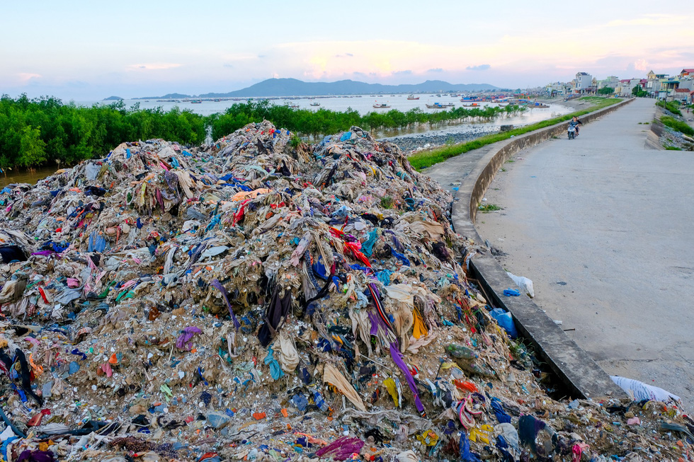 Trash piles up along a street in Vietnam.