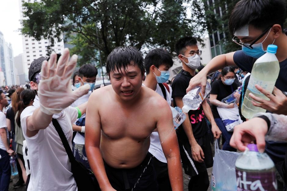A protester reacts to tear gas during a demonstration against a proposed extradition bill in Hong Kong, China June 12, 2019. Photo: Reuters