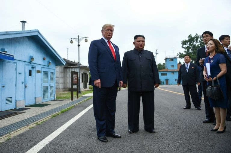 North Korea's leader Kim Jong Un stands with US President Donald Trump south of the Military Demarcation Line that divides North and South Korea. Photo: AFP