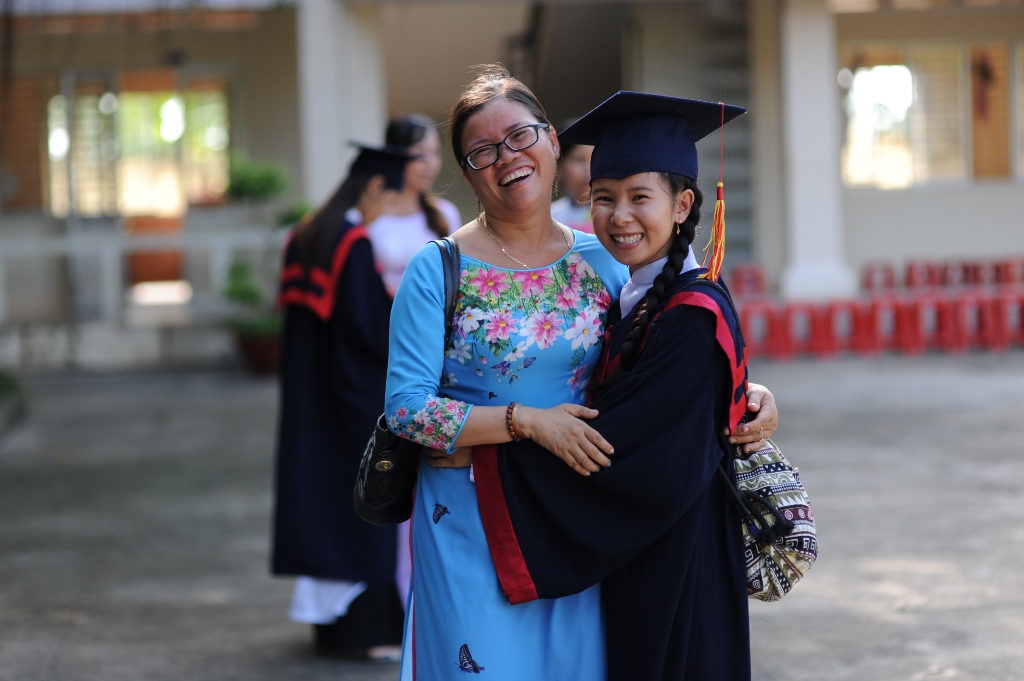 <em>Ngo Thi Kieu Loan is seen with her teacher in a photo taken on her high school graduation day. Photo: </em>Room to Read