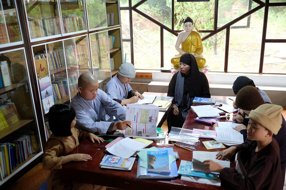 Venerable Minh Tai and other disciples at the Hue Quang monastery tutor the adopted children. Photo: Mai Vinh / Tuoi tre