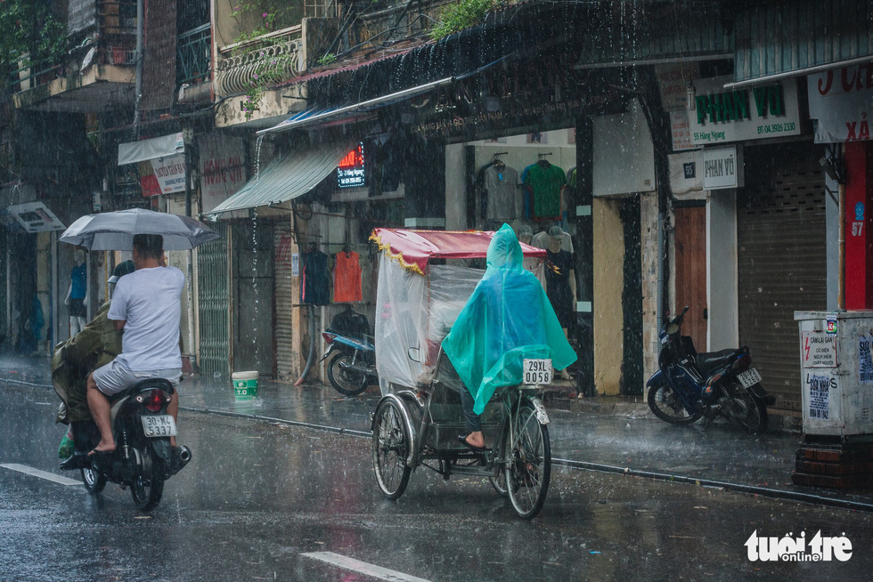 A man rides a cyclo along a street in Hanoi. Photo: Dinh Minh / Tuoi Tre
