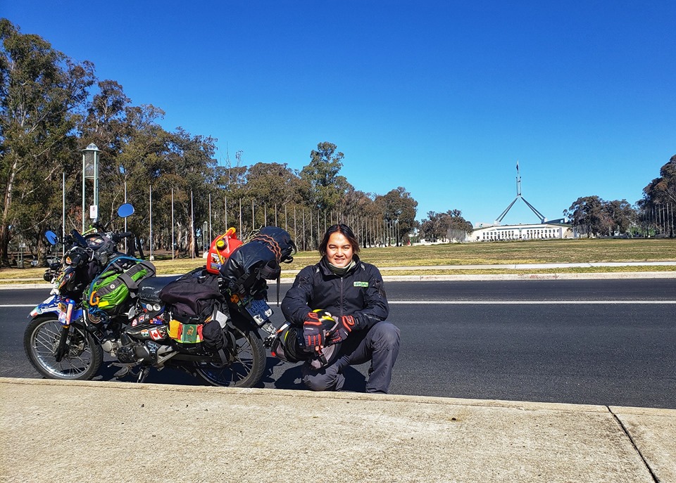 Tran Dang Dang Khoa poses for a photo with his 'The Memo'  against the background with the Parliament House in Canberra, Australia. Photo: Supplied