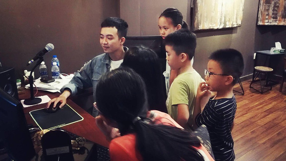 Dubbing actor Binh Nguyen records with junior dubbing members in “Hem Radio” studio. Photo: Supplied