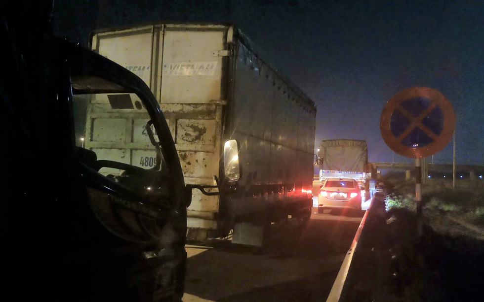 Long-haul truckers take nighttime naps along southern Vietnam expressway