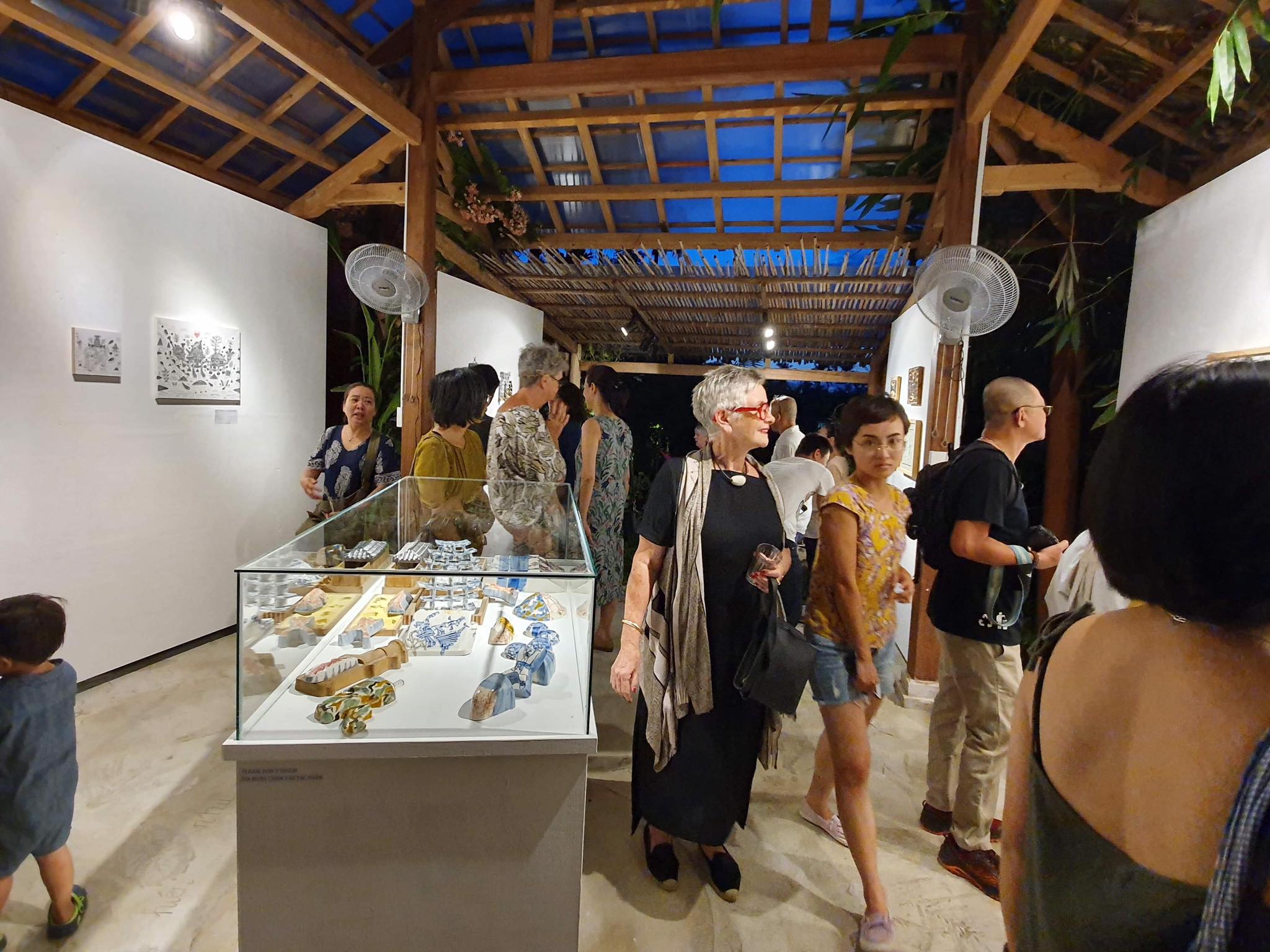 Visitors watch artworks displayed at the Molding Island City exhibition in Hoi An, central Vietnam