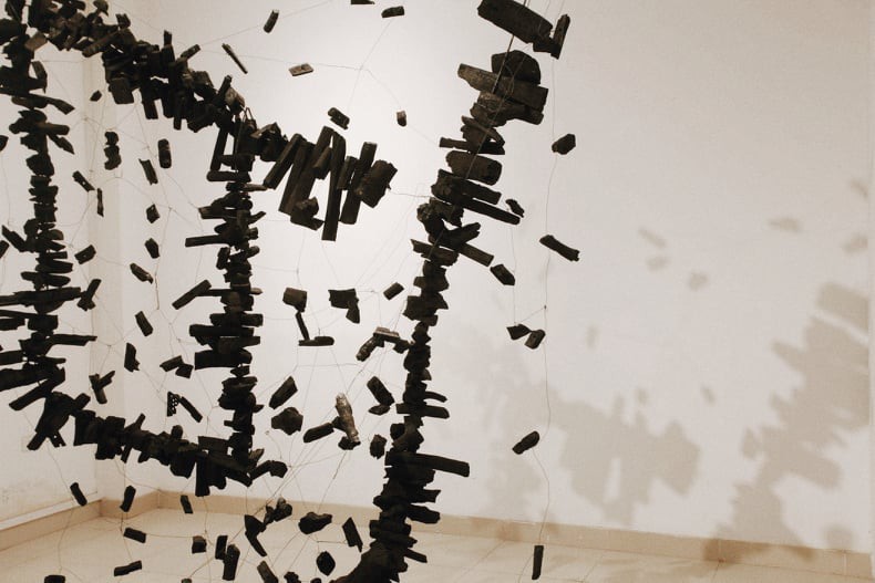 A charcoal installation is displayed at the Insect exhibition in Hanoi. Photo: Mai Thuong / Tuoi Tre