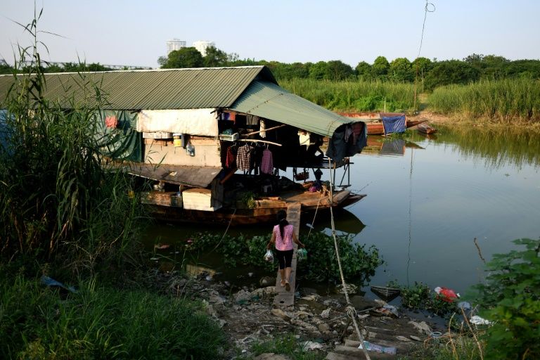 The temporary residents of open-air boats on Hanoi's Red River have left the countryside in search of higher wages in the city. Photo: AFP