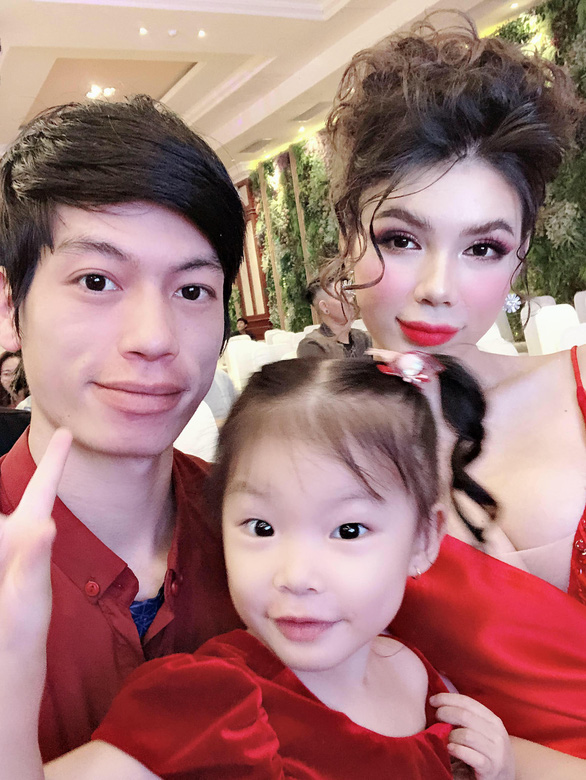 Hieu and Mi take a selfie with their adopted daughter at a party. Photo: Supplied