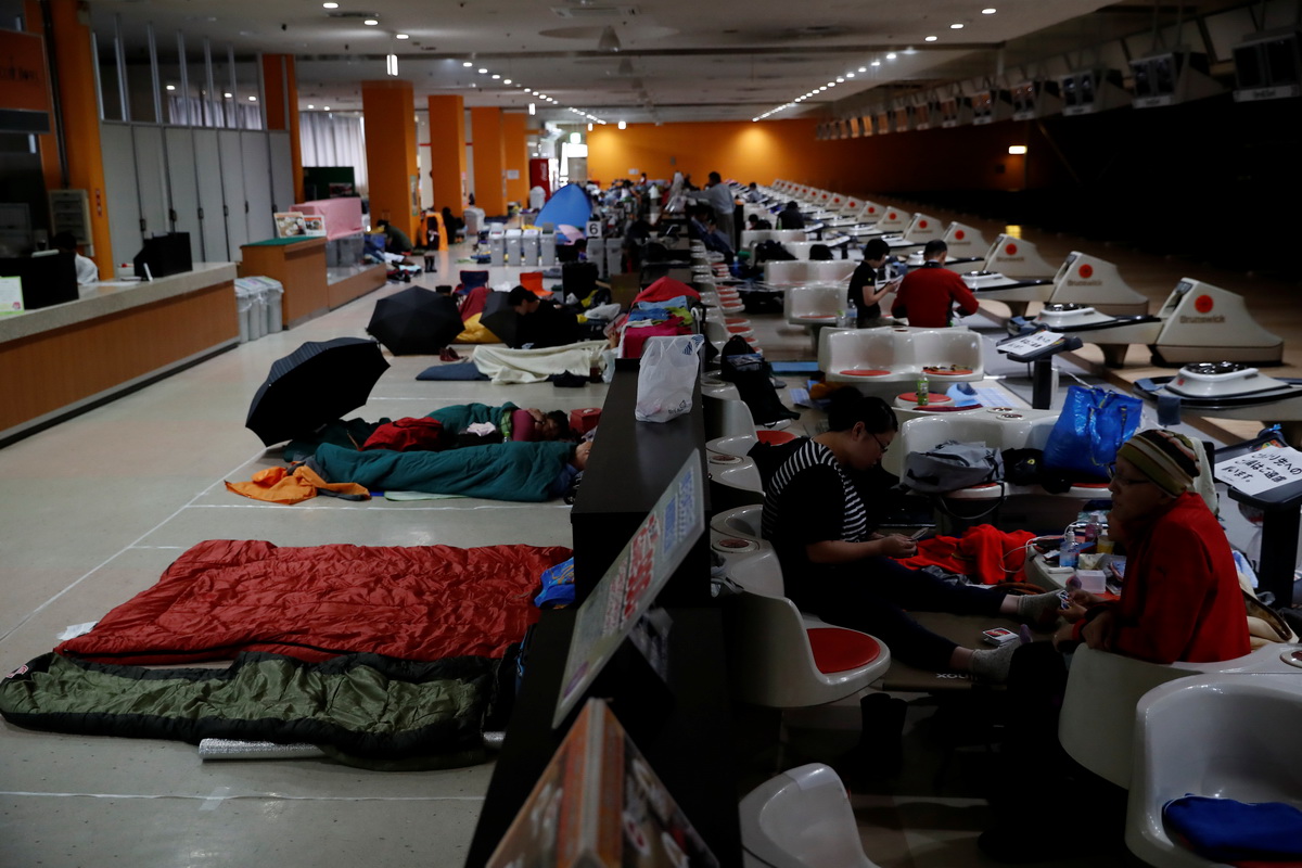 Spectators who evacuate from Typhoon Hagibis, gather at a makeshift accommodation for spectators of Formula One Japanese Grand Prix at Suzuka Circuit in Suzuka, central Japan October 12, 2019. Photo: Reuters