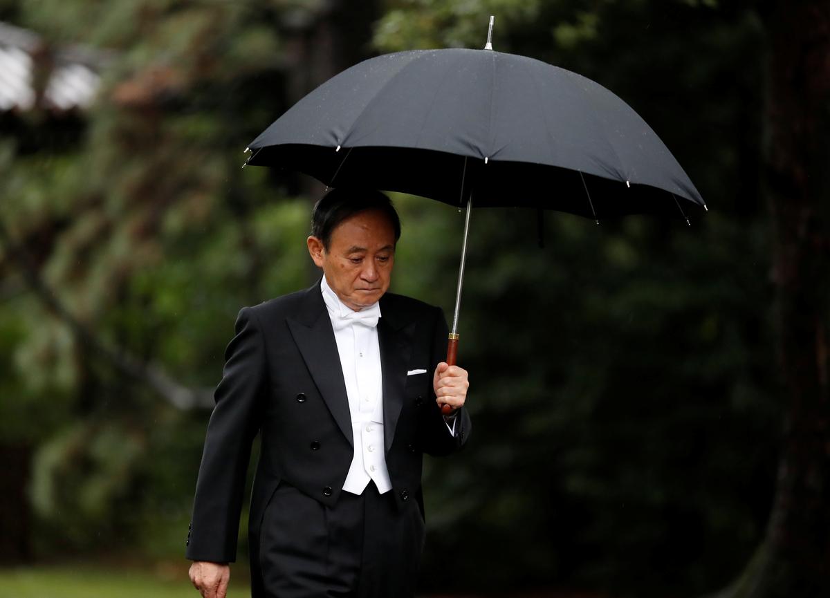 Japan's Chief Cabinet Secretary Yoshihide Suga arrives at the ceremony site where Emperor Naruhito will report the conduct of the enthronement ceremony at the Imperial Sanctuary inside the Imperial Palace in Tokyo, Japan October 22, 2019.  REUTERS/Kim Hong-ji