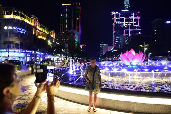 A woman poses in front of a newly opened fountain on Nguyen Hue Walking Street in District 1, Ho Chi Minh City, October 31, 2019. Photo: Quang Dinh / Tuoi Tre