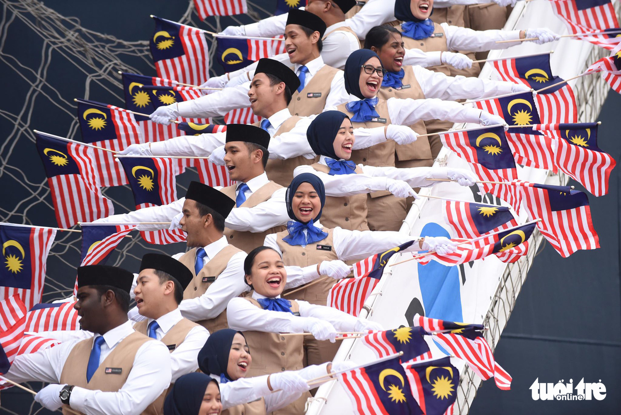 Malaysian ambassadors of the Ship for Southeast Asian and Japanese Youth Program (SSEAYP) wave their national flags as they arrive in Ho Chi Minh City, Vietnam on November 10, 2019. Photo: Duyen Phan / Tuoi Tre
