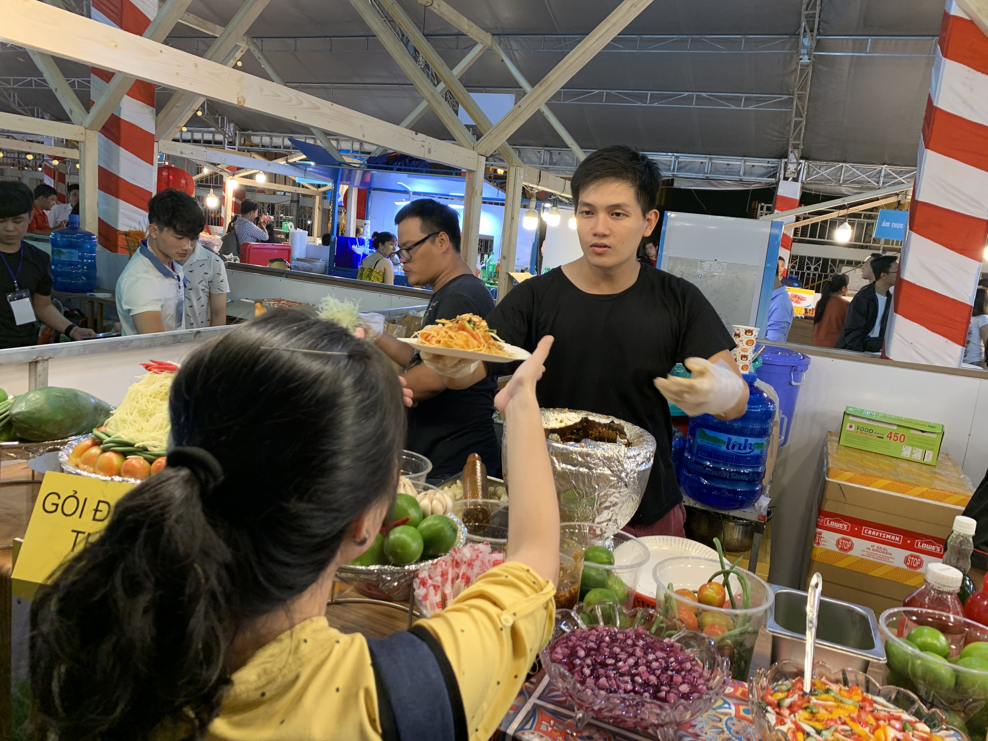 A vendor sells food from a stall at the international food festival held at the Youth Cultural House in District 1, Ho Chi Minh City, November 14, 2019. Photo: Bao Anh / Tuoi Tre News