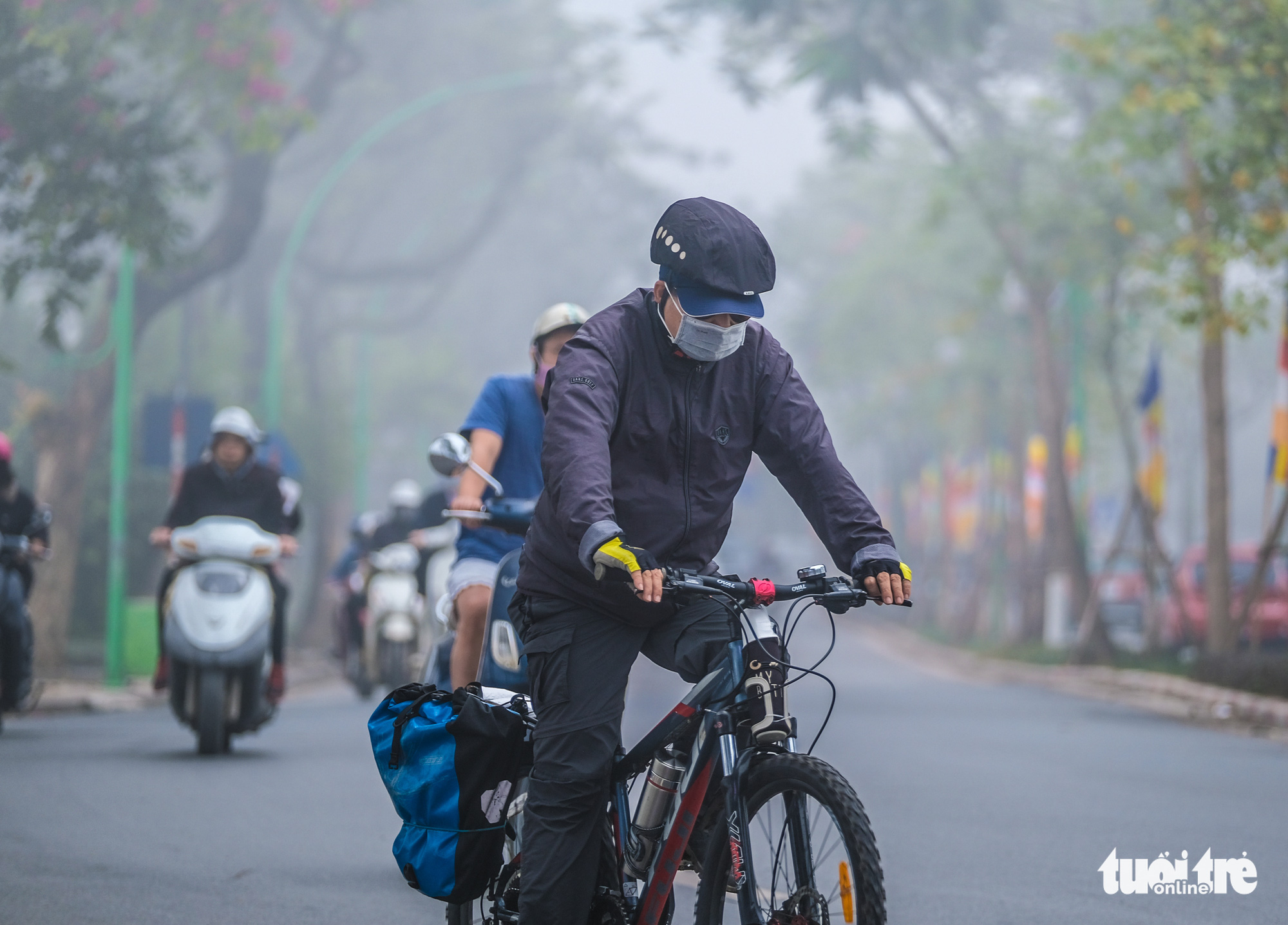 A cyclist is dressed in warm clothes in Hanoi on December 24, 2019.